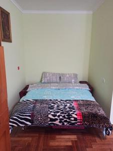 a bed with a quilt on it in a bedroom at Кульпарківська 128,економ in Lviv