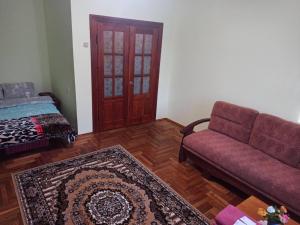 a living room with a couch and a rug at Кульпарківська 128,економ in Lviv