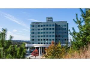 a tall building with a sign on top of it at Hotel Areaone Hiroshima Wing - Vacation STAY 62261v in Higashihiroshima