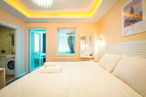 a large white bed in a room with a window at Cihangir VAV Suites in Istanbul