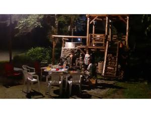 a group of people sitting at a table in a backyard at Pals Inn Raicho - Vacation STAY 74722v in Iida