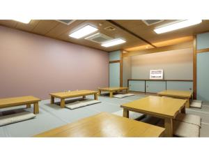 ein Klassenzimmer mit Schreibtischen und Tischen in einem Raum in der Unterkunft IyashinoYado Akariya - Vacation STAY 74775v in Kanayama