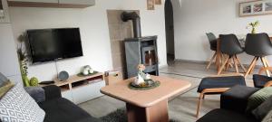 a living room with a couch and a fireplace at diemelseeholiday romantisches Ferienhaus im Sauerland Nähe Willingen Winterberg in Diemelsee