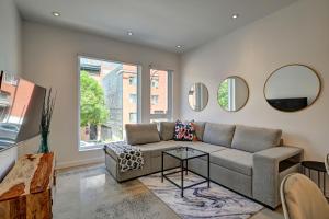 a living room with a couch and two mirrors at Amazing 1Bedroom Great Location presented by TripMontreal in Montreal
