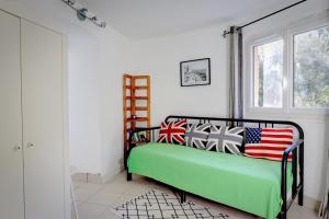 a bedroom with a bed with american flags on it at Isadora Duncan in Rayol-Canadel-sur-Mer