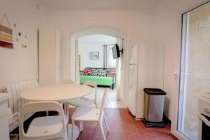 a room with a table and chairs and a refrigerator at Isadora Duncan in Rayol-Canadel-sur-Mer