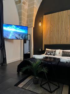 a living room with a large flat screen tv at Poesìa in Brindisi