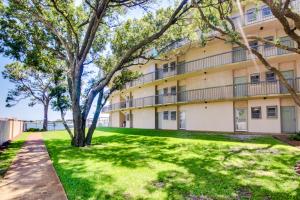 a building with a green lawn in front of it at Pirates Bay A204 in Fort Walton Beach