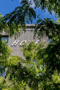 a close up of a building behind some trees at Lendhotel in Graz