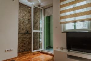 a living room with a large window and a flat screen tv at David 2 in Ruma