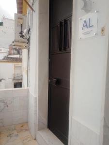 a black door in a room with a window at Casa Aires Varela in Elvas