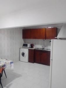 a kitchen with a refrigerator and a washing machine at Casa Aires Varela in Elvas +11 photos