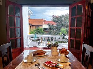 a table with food on it with a view of a balcony at Calchaquíes Home Hostel in San Salvador de Jujuy