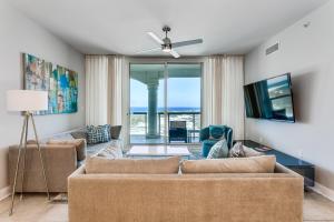 a living room with two couches and a view of the ocean at Portofino Island Resort Tower 2-703 in Pensacola Beach