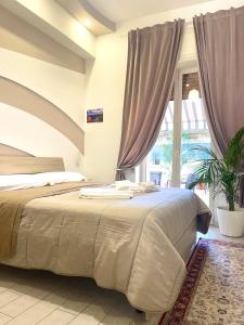 a bedroom with a bed and a large window at Terrazza Garibaldi in Naples