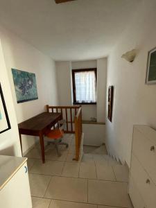 a kitchen with a table and a chair and a window at Nel Borgo in Verrès