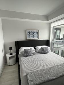 Säng eller sängar i ett rum på Stunning Stayz At Friday Harbour Beach Marina Resort Lake Simcoe Innisfil