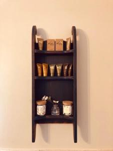 a shelf on a wall with pots and boxes at High Meadows Estate in Purcellville