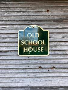 an old school house sign on the side of a building at High Meadows Estate in Purcellville