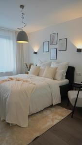 a bedroom with a large bed with white sheets at Hotel Fewotal & Luxury 5 - nähe Messe Düsseldorf & Köln in Wuppertal