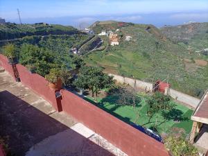 a view of a hill from a wall with plants at Chalet Ruta El Saucillo in Gáldar