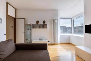 a living room with a couch and a large window at Il Loft di Guido in Vicenza