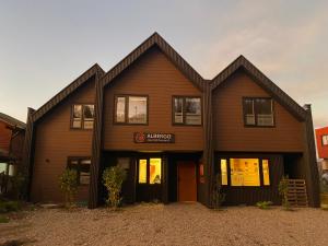 een groot houten gebouw met een bord erop bij Albergo B&B in Panguipulli