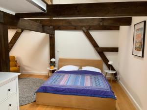 a bedroom with a bed and wooden ceilings at Urlauberei Malchow in Malchow