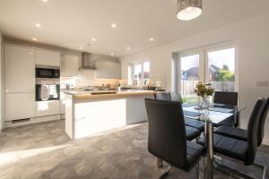 a kitchen and dining room with a table and chairs at No203 in Doncaster