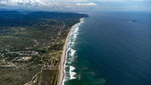 an aerial view of the ocean and a beach at Hostal Mirada al Mar in Las Tunas
