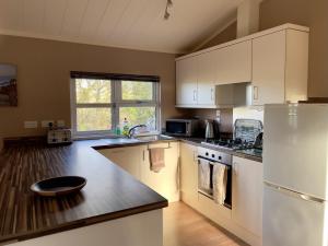 a kitchen with white cabinets and a white refrigerator at The Maples in Narberth