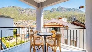 a balcony with a table and chairs and a view at Larex Otel in Kaş