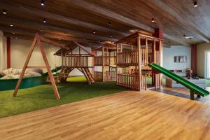 a play room with several swings and a slide at Hotel em Gramado - Buona Vitta in Gramado