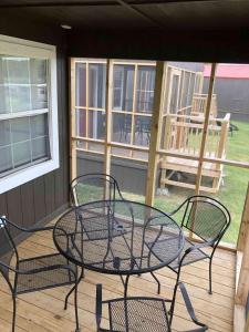 a patio with a table and chairs on a porch at Lakefront Cabin - Sunset Cove - 15 in Mead