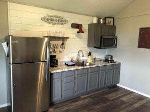 a kitchen with a stainless steel refrigerator and a sink at Lakefront Cabin - Sunset Cove - 15 in Mead +2 photos