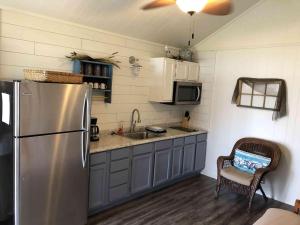 a kitchen with a stainless steel refrigerator and a sink at Lakefront Cabin - Texoma Coast - 14 in Mead
