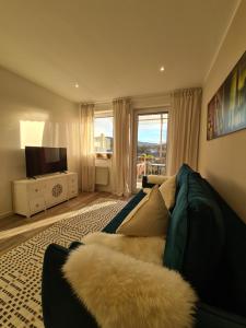 a living room with a couch and a television at Ferienwohnung Rosenberg in Konz-Oberemmel