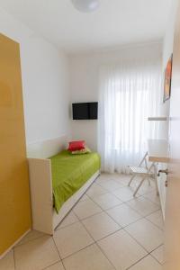 a bedroom with a bed with a green blanket at BDREAMS APARTAMENT in Castellammare di Stabia
