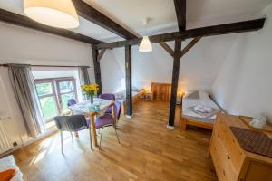 a living room with a table and chairs and a bedroom at Żywkowo Bocianie Gospodarstwo Rolne in Górowo Iławeckie