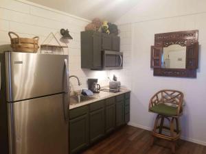 a kitchen with a stainless steel refrigerator and a sink at Lakefront Cabin - Texoma Breeze - 12 in Mead