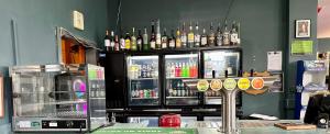 eine Bar mit Alkoholflaschen an der Wand in der Unterkunft Club Hotel Pahiatua in Pahiatua
