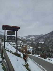 una señal en el costado de una carretera cubierta de nieve en La Faya - La Vallicuerra Casas Rurales en Mieres