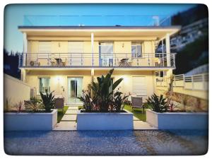 a large yellow house with plants in front of it at Le Vallaya Suites & Spa in Menton