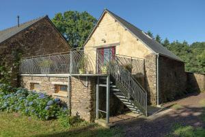 a house with a staircase on the side of it at Le Nourhoët havre de Paix à l'Orée de Brocéliande in Campénéac