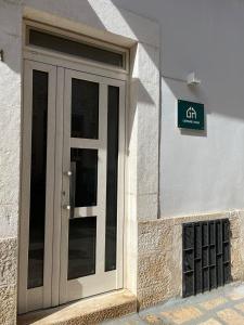 a door on the side of a building with a sign at Gasparro House in Turi