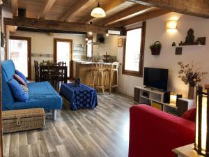 a living room with a couch and a tv at Old town Superbistak in Lekeitio