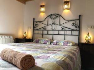 a bedroom with a large bed with two lamps at Old town Superbistak in Lekeitio