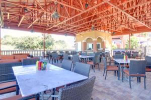 an empty patio with tables and chairs and tablesktop at Portofino 2-1906 in Pensacola Beach
