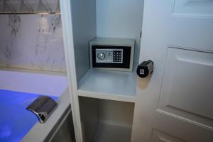 a small cabinet with a microwave in a room at Sole Luxury Bed and Breakfast in Naples