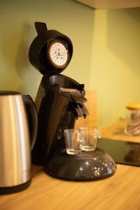 a coffee maker with a clock on top of it at Fresh&Relax in Chamalières
